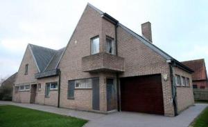 a large brick house with a large garage at Smiley in Blankenberge