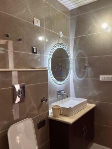 a bathroom with a sink and a mirror at The Grand K2 Hotel in Leh