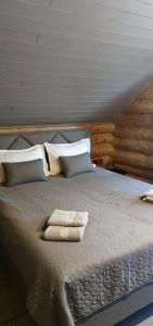 a bed with two towels on top of it at Loft Bucovina in Gura Humorului