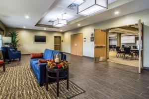 a lobby with a blue couch and a table at Comfort Suites Hotel and Conference Center in Berlin