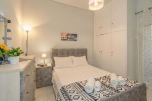 a small bedroom with a bed and a desk at Comfy Apt next to metro in Athens