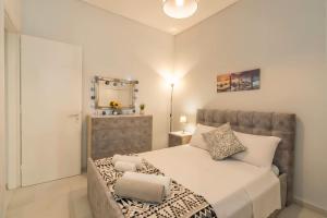 a bedroom with a large bed and a mirror at Comfy Apt next to metro in Athens