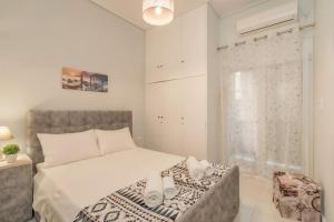 a bedroom with a large bed and a window at Comfy Apt next to metro in Athens