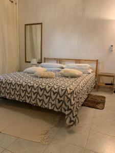 a bed with pillows on it in a room at oasi di Villa Erbosa in Bologna