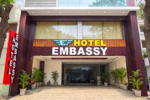 a hotel entrance with a hotel embassy sign in front at The EMBASSY HOTEL in Guntūr