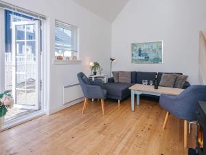 a living room with a couch and a table at 4 star holiday home in Ringkøbing in Ringkøbing +48 photos