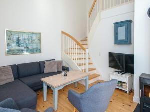a living room with a couch and a table at 4 star holiday home in Ringkøbing in Ringkøbing