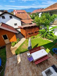 a patio with an umbrella and a table and chairs at Apartman Layla in Bihać
