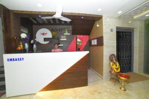 a woman sitting at a counter in a store at The EMBASSY HOTEL in Guntūr