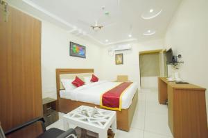 a hotel room with a bed and a bathroom at The EMBASSY HOTEL in Guntūr