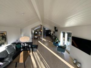 a living room with a couch and a table at Natur, fjord og hygge nær Roskilde in Kirke-Hyllinge
