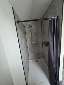a shower in a bathroom with a shower curtain at St Marys Cottage 2 in Dover +25 photos