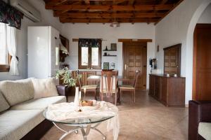 a living room with a couch and a table at House Demetra in Astris