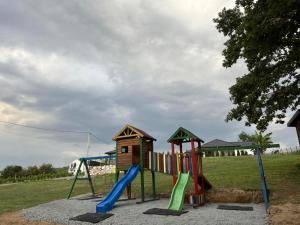a playground with a slide and a play structure at Art Residence in Tuzla