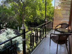 a balcony with a table and chairs on a porch at Kausar Hotel in Bishkek +53 photos