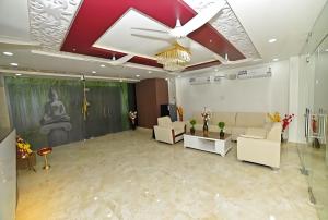 a living room with white furniture and a ceiling at The EMBASSY HOTEL in Guntūr +2 photos