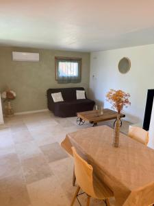 a living room with a couch and a table at Studio avec terrasse et parking privé in Château-Arnoux-Saint-Auban