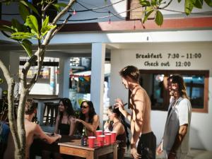 a group of people standing outside of a restaurant at Gili Pirates Dive & Social Hostel in Gili Trawangan