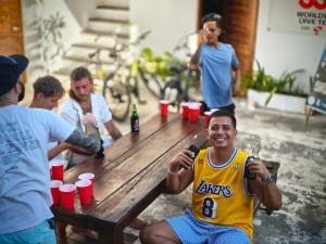 a basketball player sitting at a picnic table holding microphones at Gili Pirates Dive & Social Hostel in Gili Trawangan +52 photos