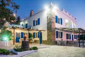 a villa with blue doors and a courtyard at night at Lotos Suite in Kini