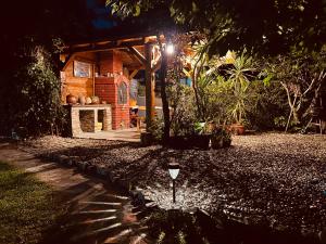a garden at night with a small house at Bubinga in Kruševac