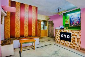 a restaurant with a table and a bench in a room at Hotel cozy guest house in Alīgarh
