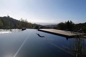 a pool of water with a view of a mountain at O Vale in Ericeira