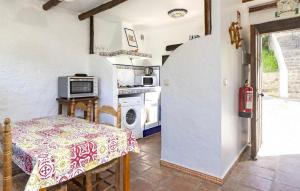 a small kitchen with a table and a stove at Casa Rural La Albahaca in Jimera de Líbar
