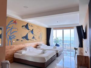 a bedroom with two beds with birds on the wall at De Mer Resort Rayong in Ban Ao Makham Pom +38 photos