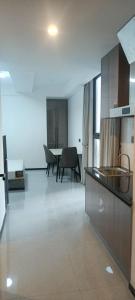a kitchen and dining room with a table and chairs at CondoApsara in Phnom Penh