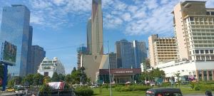 a city with tall buildings and cars on a street at CondoApsara in Phnom Penh