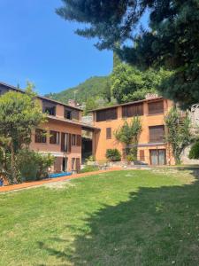 a building with a grass yard in front of it at Lakefront holiday in Salò +30 photos