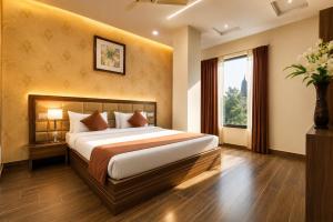 a bedroom with a large bed and a window at Hotel Shiv Shakti in Rajkot