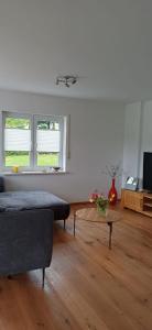 a living room with a couch and a table at Top Ferienwohnung Herborn in Herborn