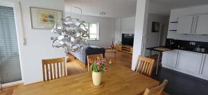 a kitchen and dining room with a table with a vase of flowers at Top Ferienwohnung Herborn in Herborn