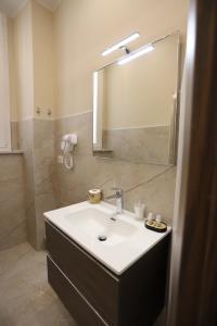 a bathroom with a sink and a mirror at Palazzo Campisi rooms in Tropea