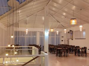 a dining room with tables and chairs and lights at Harrington Heritage in Hatton