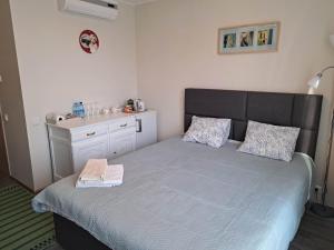 a bedroom with a bed and a dresser at Aisa Street apartments in Pärnu
