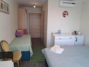 a small room with two beds and a sink at Aisa Street apartments in Pärnu