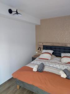 a bedroom with a large bed with two pillows at L'Escale Baie in Pendé