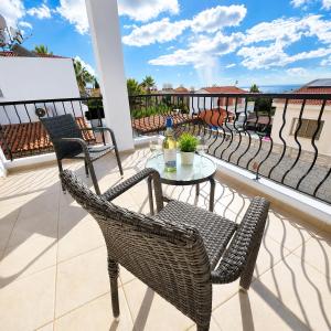 a patio with a table and chairs on a balcony at Villa Athena in Peyia