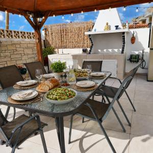 a table with food on it on a patio at Villa Athena in Peyia