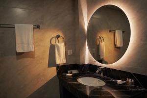 a bathroom with a sink and a mirror and towels at Hispar Hotel Skardu in Skardu +41 photos