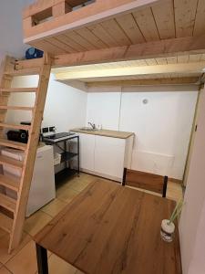 a room with a loft bed and a kitchen at Casa sole Sicilia in Alcamo