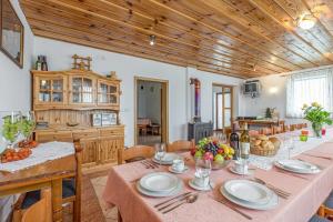 a kitchen and dining room with a table and chairs at Vrtin Vineyard Family Retreat - Happy Rentals in Dragatuš