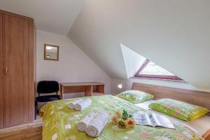 a bedroom with a bed with towels on it at Vrtin Vineyard Family Retreat - Happy Rentals in Dragatuš +35 photos