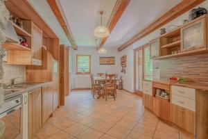 eine Küche mit Holzschränken und ein Esszimmer in der Unterkunft Chalet Primus in Soča Valley - Happy Rentals in Soča