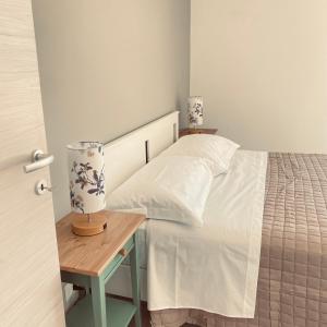 a bedroom with a bed and a table with a lamp at Etna Rooftop in Trecastagni