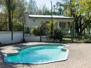 a small swimming pool in front of a house at Petronella Guest House in Bethlehem