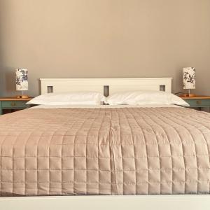 a bedroom with a large bed with two lamps at Etna Rooftop in Trecastagni